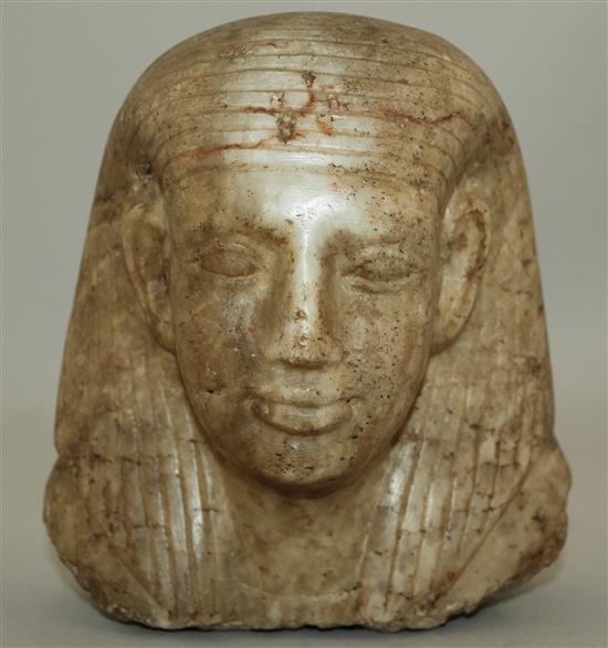 An Egyptian quartzite bust of a man, late period (26th dynasty), possibly a priest, height 17cm